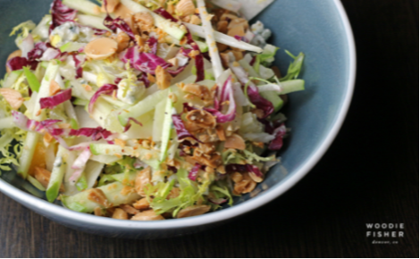 eGift card image of a salad with the Woodie Fisher Kitchen & Bar logo