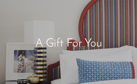 Gift card image of bed and side table with the text “A Gift For You”