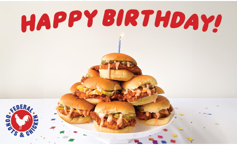 A cake made of fried chicken sandwiches with the heading "Happy Birthday!" and a small Federal Donuts & Chicken badge logo on the bottom left.