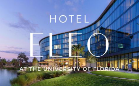 This image is of the hotel at sunset and the hotels logo is large and covers most of the image. 